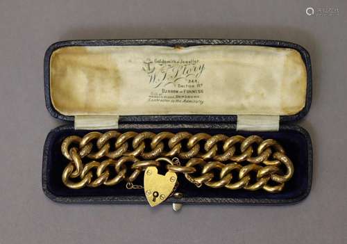 A 9ct gold bracelet of part-engraved curb-links, with padloc...