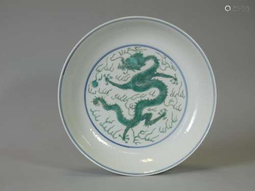 A Chinese porcelain shallow dish, with painted dragon decora...