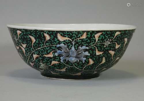 A Chinese porcelain deep bowl of black ground, decorated wit...