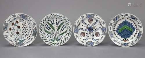 A set of four modern pottery shallow dishes decorated in the...