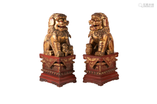 PAIR OF CHINESE WOOD RED & GILT GUARDIAN FU LIONS