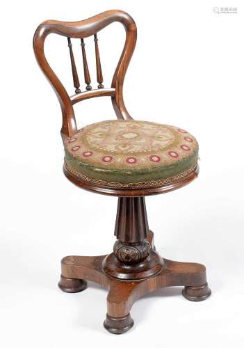 A Victorian rosewood balloon-back harpists chair.