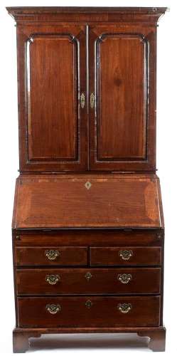 A George III mahogany and banded bureau cabinet, the upper s...