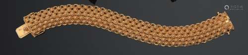 Bracelet articulé en or jaune 750 millièmes, le centre gravé...