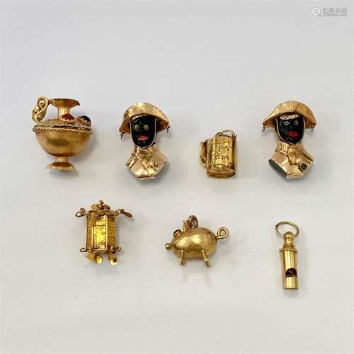 COLLECTION DE SEPT CHARMS A collection of seven 18K and 9K y...