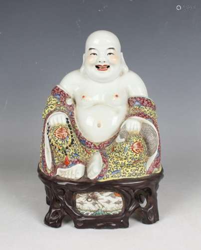 A Chinese porcelain figure of Buddha, early 20th century, mo...
