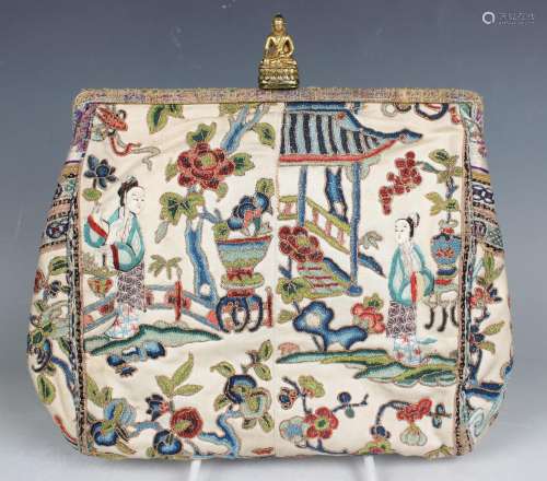 A Chinese silk embroidered purse with gilt Buddha clasp, ear...