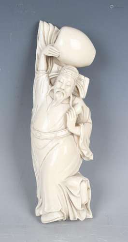 A Chinese carved ivory figure, late Qing dynasty, modelled a...