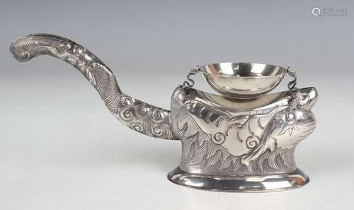 A 20th century Vietnamese .900 silver tea strainer and stand...