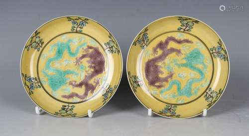 A pair of Chinese famille verte yellow ground enamelled bisc...