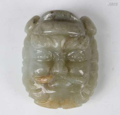 A Chinese pale celadon jade bearded immortal mask buckle/pen...