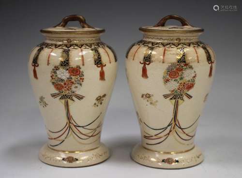 A pair of Japanese Satsuma earthenware vases and covers by H...