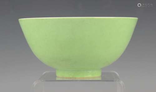 A Chinese lime green glazed porcelain circular bowl, mark of...