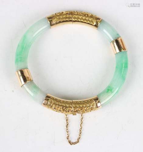 A Chinese jade and gold mounted hinged bangle, 20th century,...