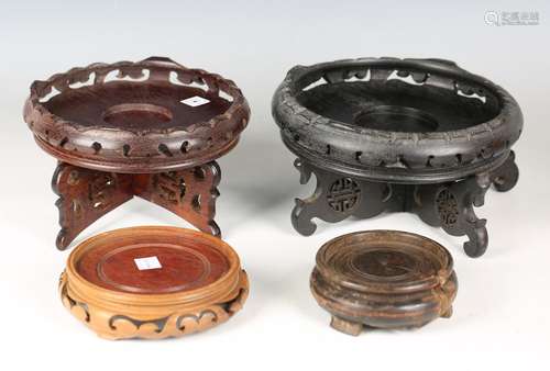 A small group of twelve Chinese carved wood stands, mostly 2...