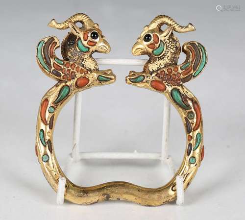 A South-east Asian Tibetan style gilt metal bangle, cast wit...