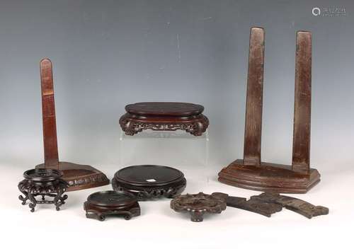 A collection of twenty-nine mostly Chinese wood stands, late...