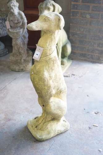 A reconstituted stone figure of a seated greyhound, height 7...