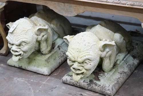 A pair of stone gargoyle garden ornaments, length 60cm, dept...