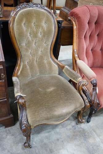 A Victorian carved walnut upholstered spoonback open armchai...