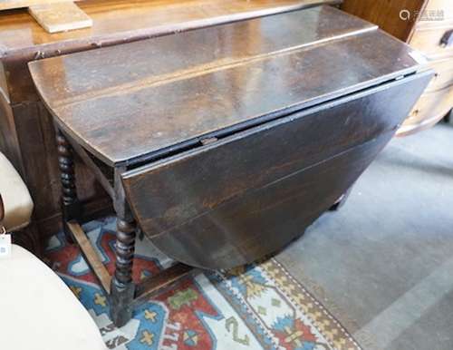 An 18th century oval oak gateleg dining table on bobbin unde...