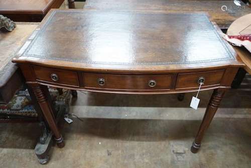 A Regency style mahogany bow front three drawer writing tabl...