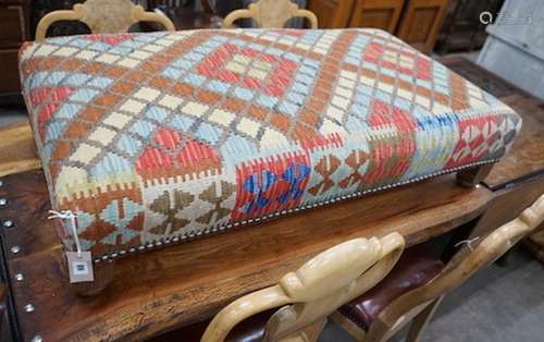 A rectangular Kelim footstool on oak feet, length 114cm, dep...