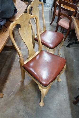 A set of four Queen Anne style pale walnut dining chairs wit...