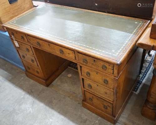 A Victorian light oak pedestal desk, fitted nine small drawe...
