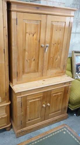 A modern pine dresser, enclosed by two pairs of fielded pane...