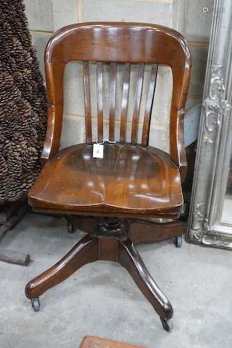 An early 20th century American walnut swivel desk chair by t...