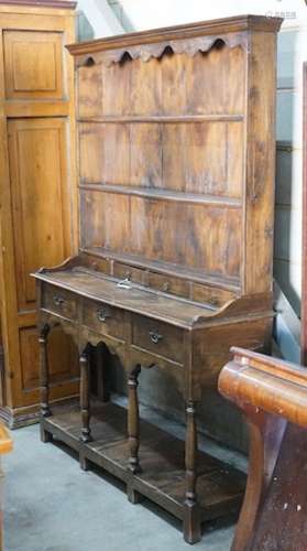 An 18th century style elm pot board dresser with boarded rac...