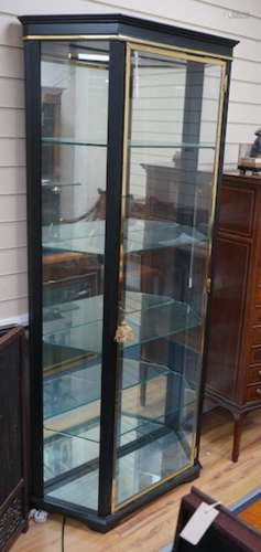 A brass mounted black painted display cabinet with interior ...