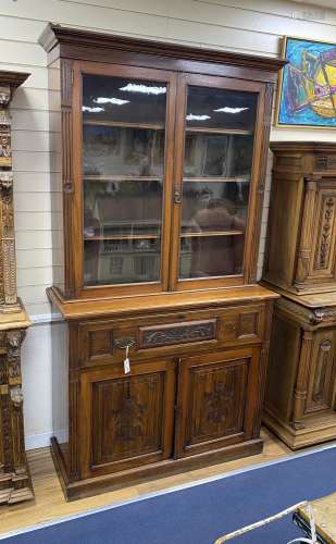 A late Victorian carved walnut secretaire bookcase, length 1...
