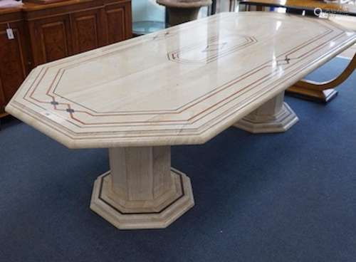 A Travertine marble dining table of elongated octagonal form...