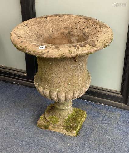 A reconstituted stone fluted campana shaped garden urn, diam...
