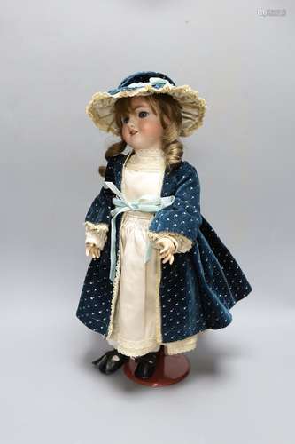 A Simon & Halbig doll, cream satin dress and blue velvet...