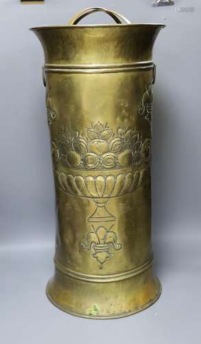 An embossed brass stick stand,66cms high.