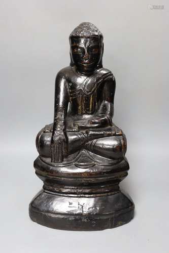 An 18th/19th century Burmese lacquered wood seated figure of...