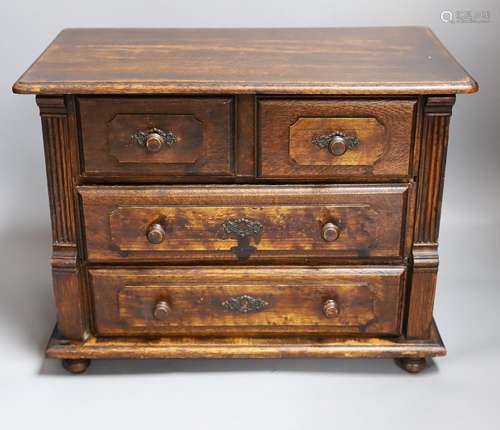 A 19th century miniature oak chest of drawers,40 cms wide.