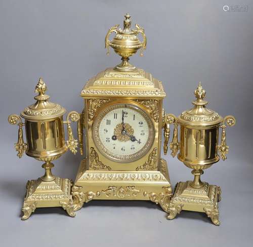 An early 20th century gilt brass three piece clock garniture...