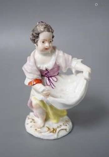 An 18th century Meissen figure of a girl holding her apron t...