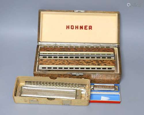 Three cased Hohner harmonicas including a chronomatica no.26...