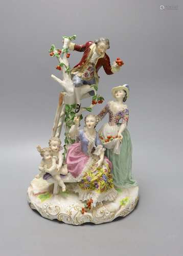 A large German porcelain group of figures picking fruit from...