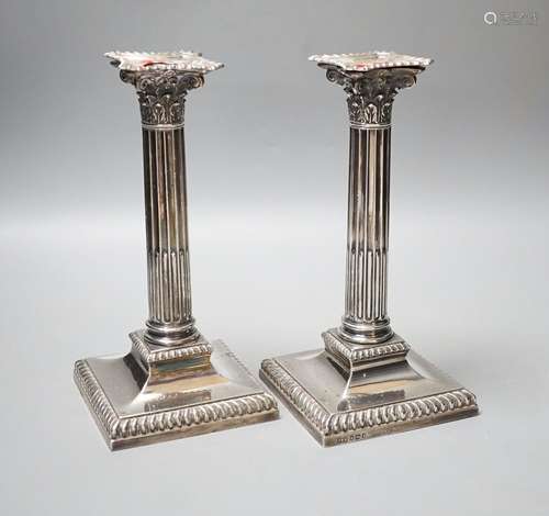 A pair of late Victorian silver Corinthian column candlestic...