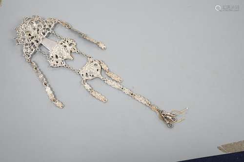 An Edwardian silver chatelaine, pierced and decorated with m...