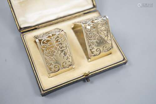 A late Victorian cased pair of pierced silver triangular nap...