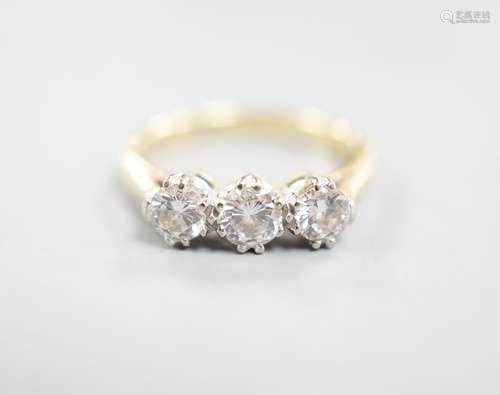 A modern 18ct gold and three stone diamond set ring, size J,...