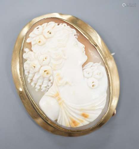 A yellow metal mounted oval cameo shell brooch, carved with ...