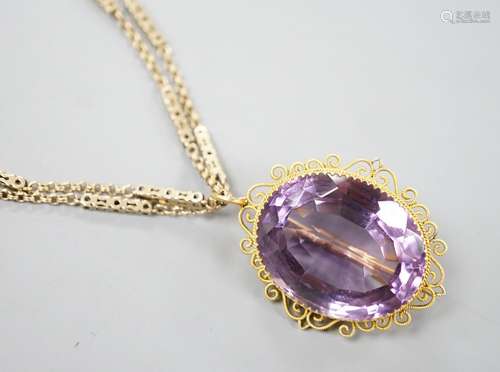 A yellow metal mounted oval cut amethyst pendant brooch, 34m...